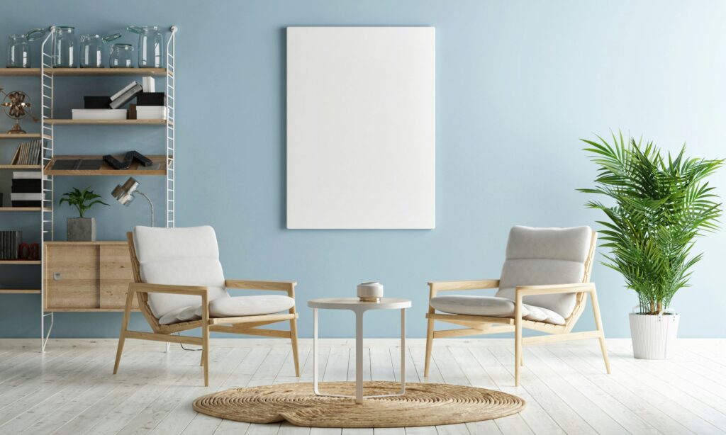 Furnished sitting area with a pale blue wall, shelving and two chairs